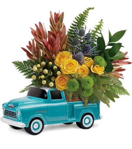 Yellow roses arranged in a turquoise toy truck