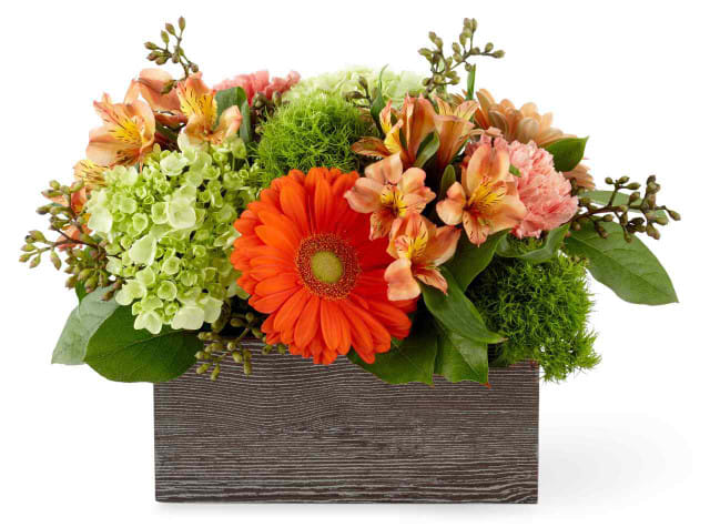 Mixed bouquet in a rectangular wooden box with orange and peach flowers