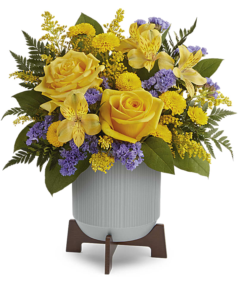 Blooming Modern Bouquet - Cool and contemporary meets bright and fun! Cheerful yellow roses get a modern touch in this sleek ceramic planter with warm wood base. Radiant yellow roses, yellow alstroemerias, yellow button spray chrysanthemums, and blue sinuata statice are accented with solidago, lemon leaf, leatherleaf ferns. Delivered in Teleflora's Classic Contemporary Planter.