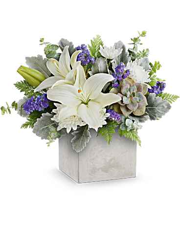 White lilies and purple flowers arranged in a square box