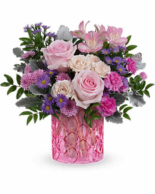 Teleflora's Haute Pink - Blush pink roses and clusters of cream spray roses create the romantic heart of this flower arrangement, making it an ideal birthday bouquet or anniversary roses gift that reads feminine and celebratory. Lavender-purple asters and bright pink carnations add pops of color and cheerful texture, while soft pink alstroemeria lift the composition with graceful height-the kind of arrangement that will make the person you're thinking of feel genuinely seen and uplifted.  