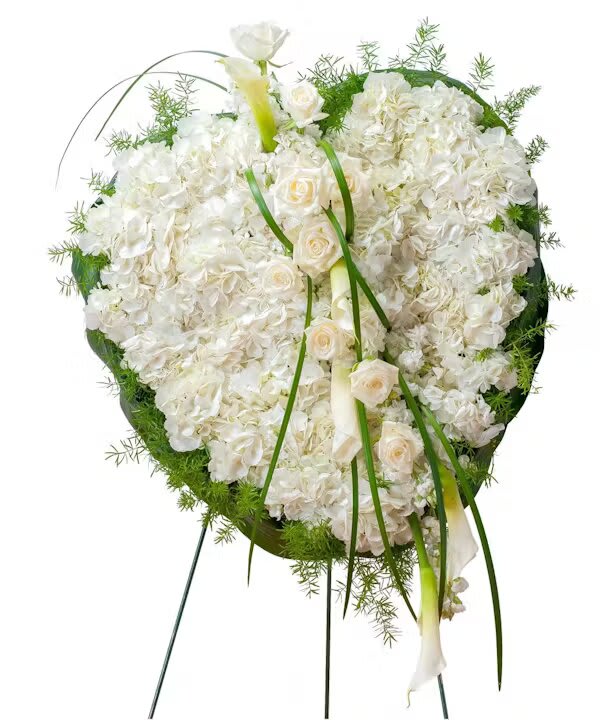 White floral standing wreath with calla lilies and roses on a metal easel