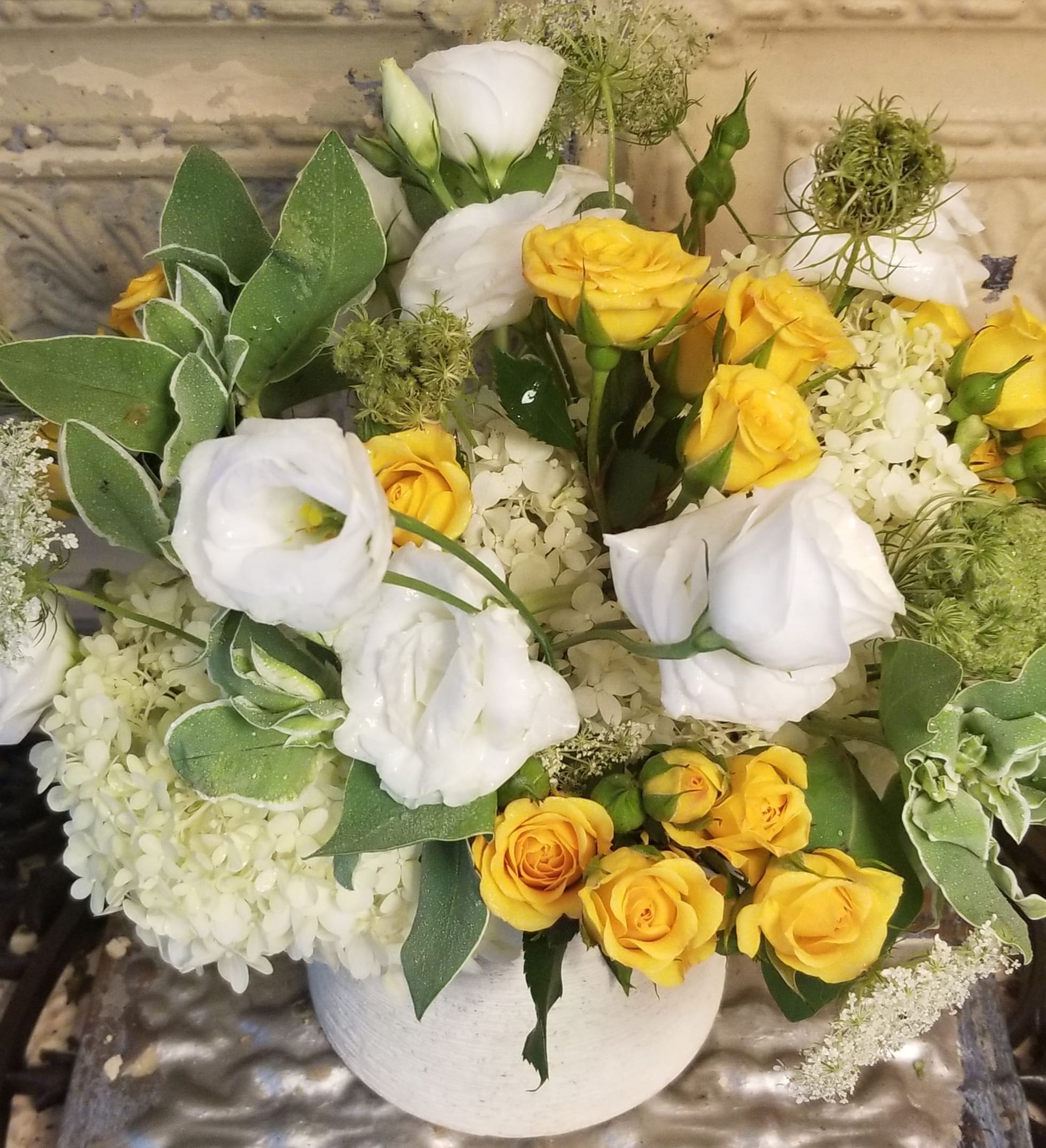 Yellow and white rose bouquet in a white vase
