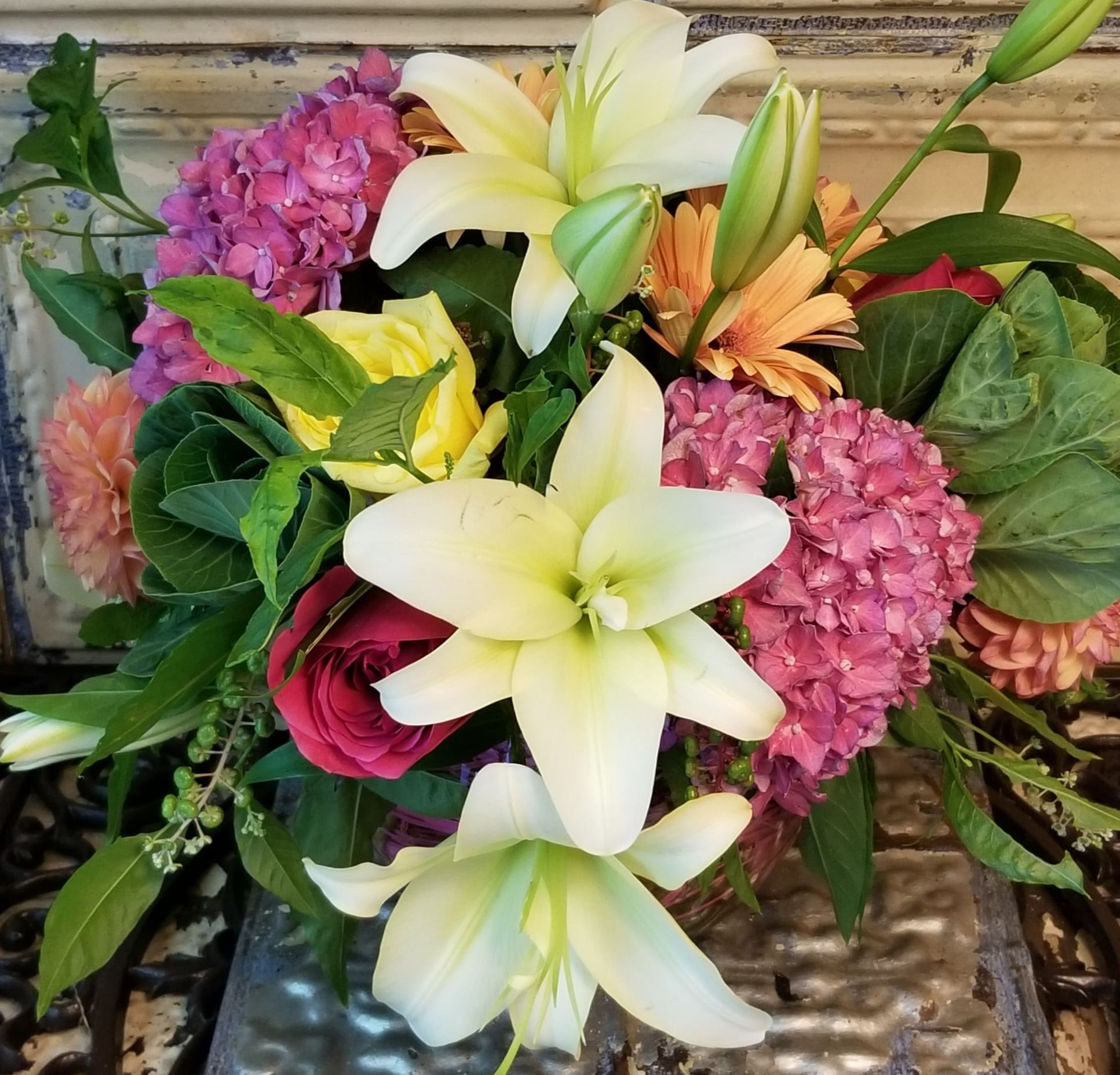 Bouquet of white lilies, pink hydrangeas, and mixed roses