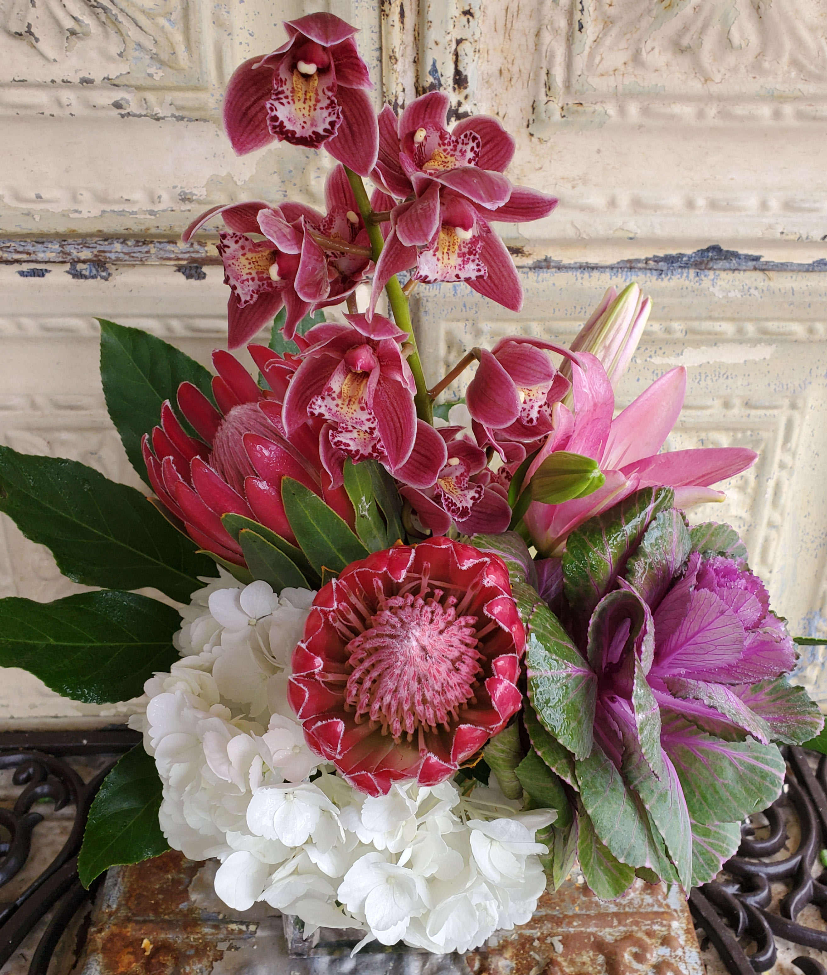 Pink orchids and mixed blooms arranged in a compact bouquet