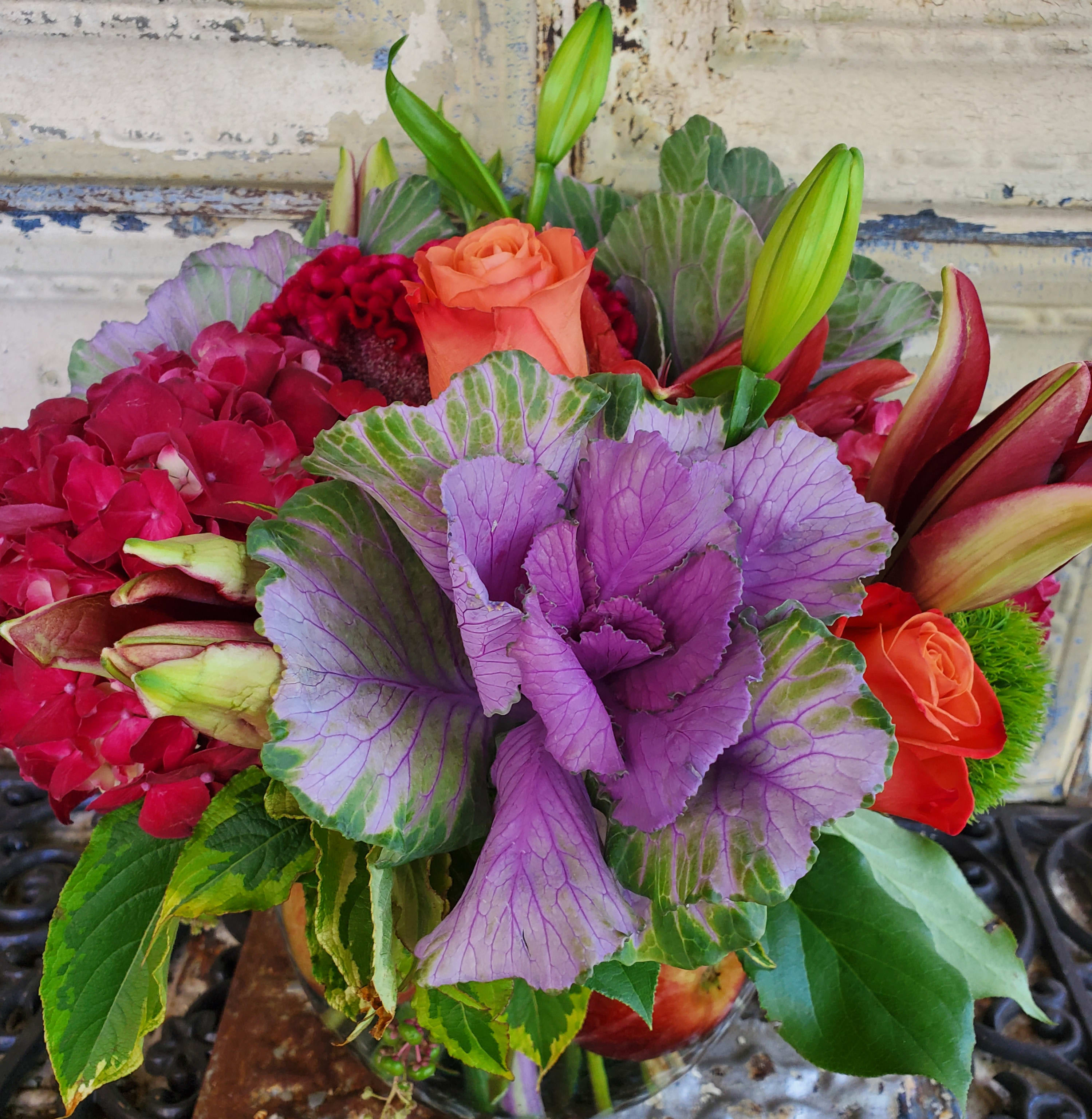 Bouquet with orange roses, lilies, hydrangea, and purple ornamental cabbage