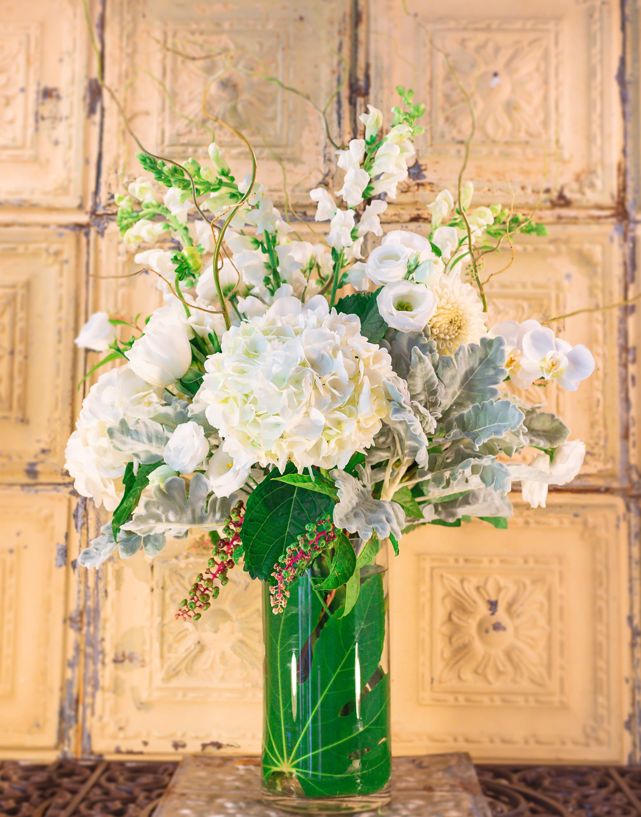 White floral arrangement in a clear glass vase