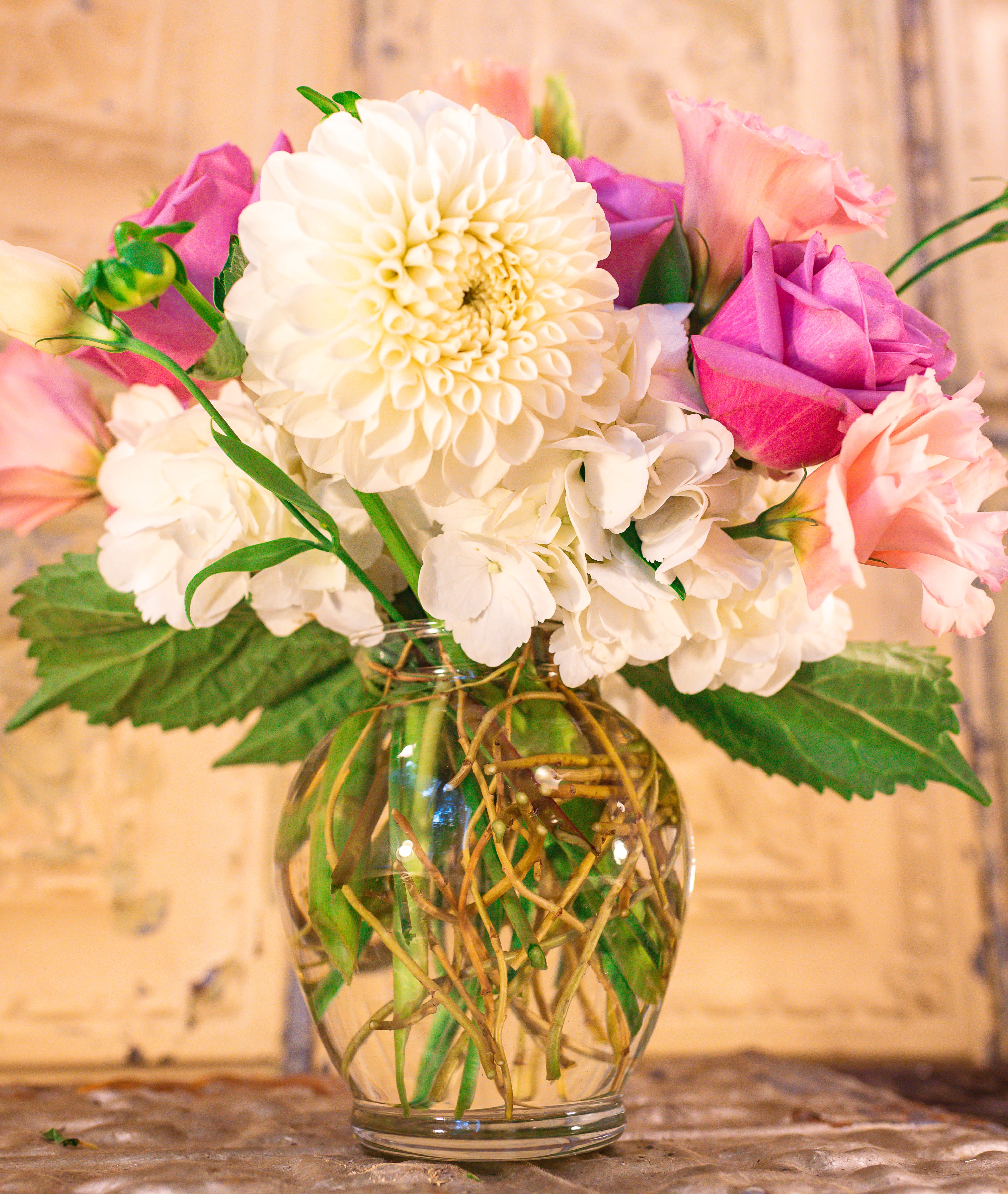 Bouquet of white and pink flowers in a clear glass vase