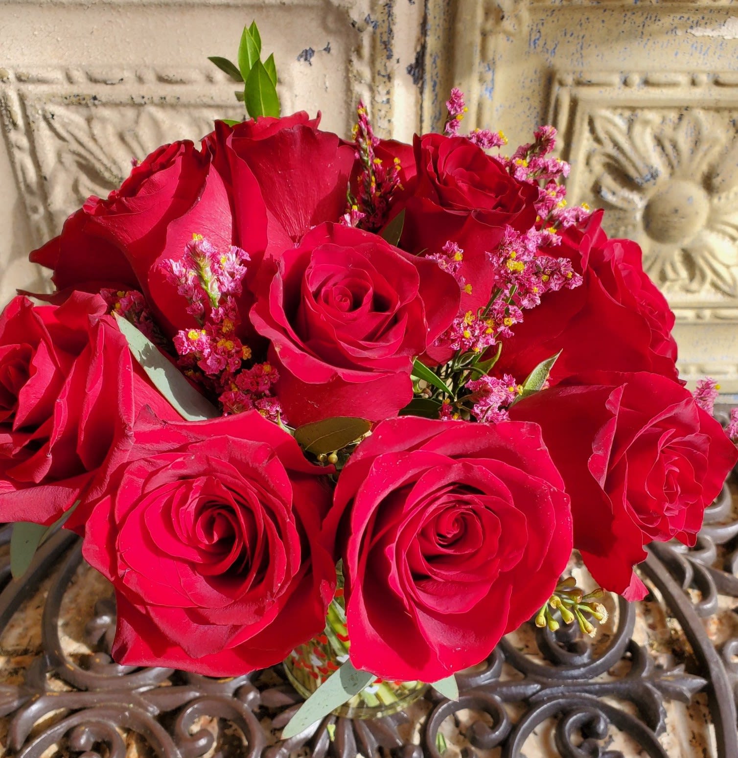 Bouquet of red roses with small pink filler flowers