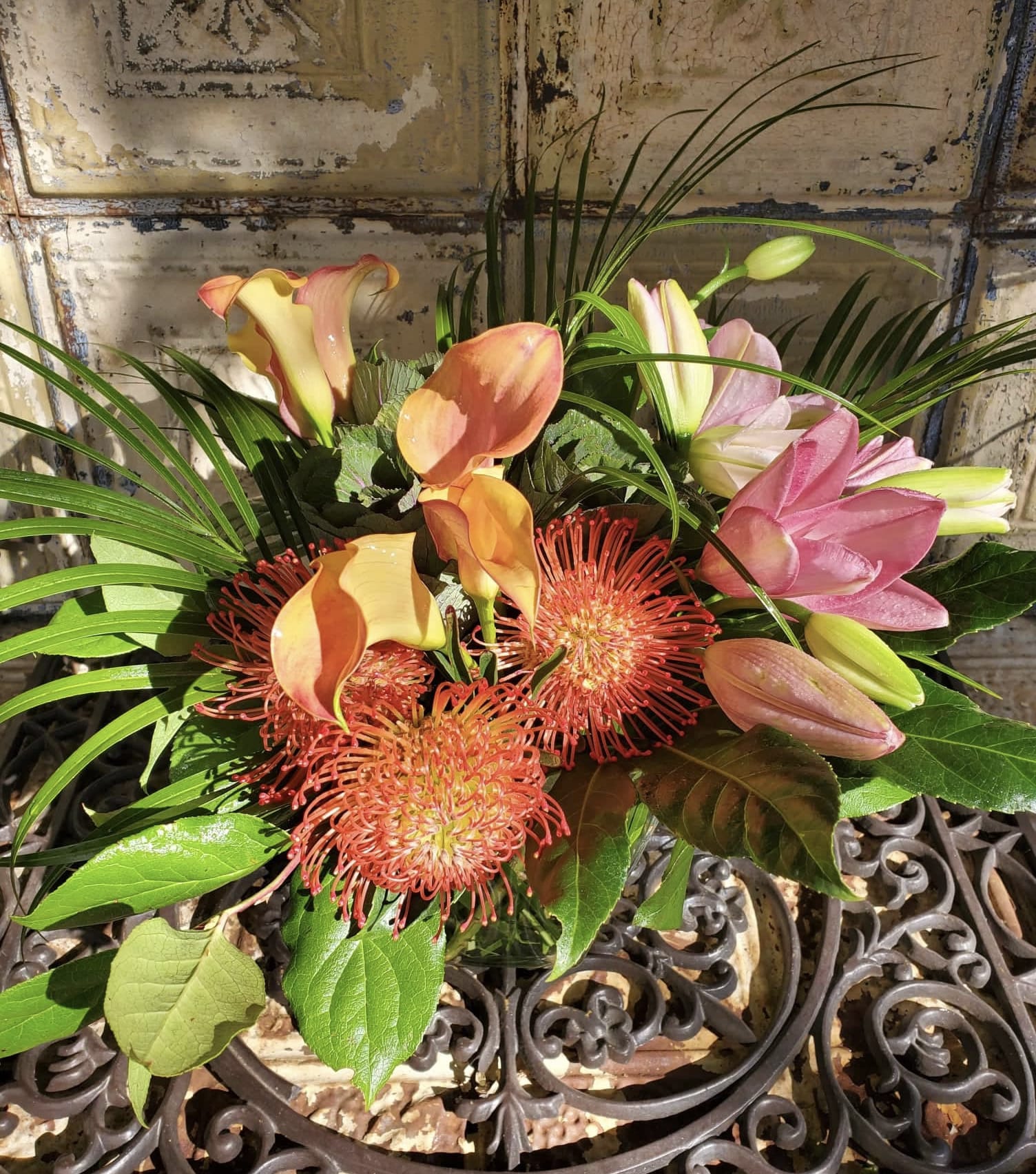 Bouquet with pink calla lilies and orange pincushion blooms