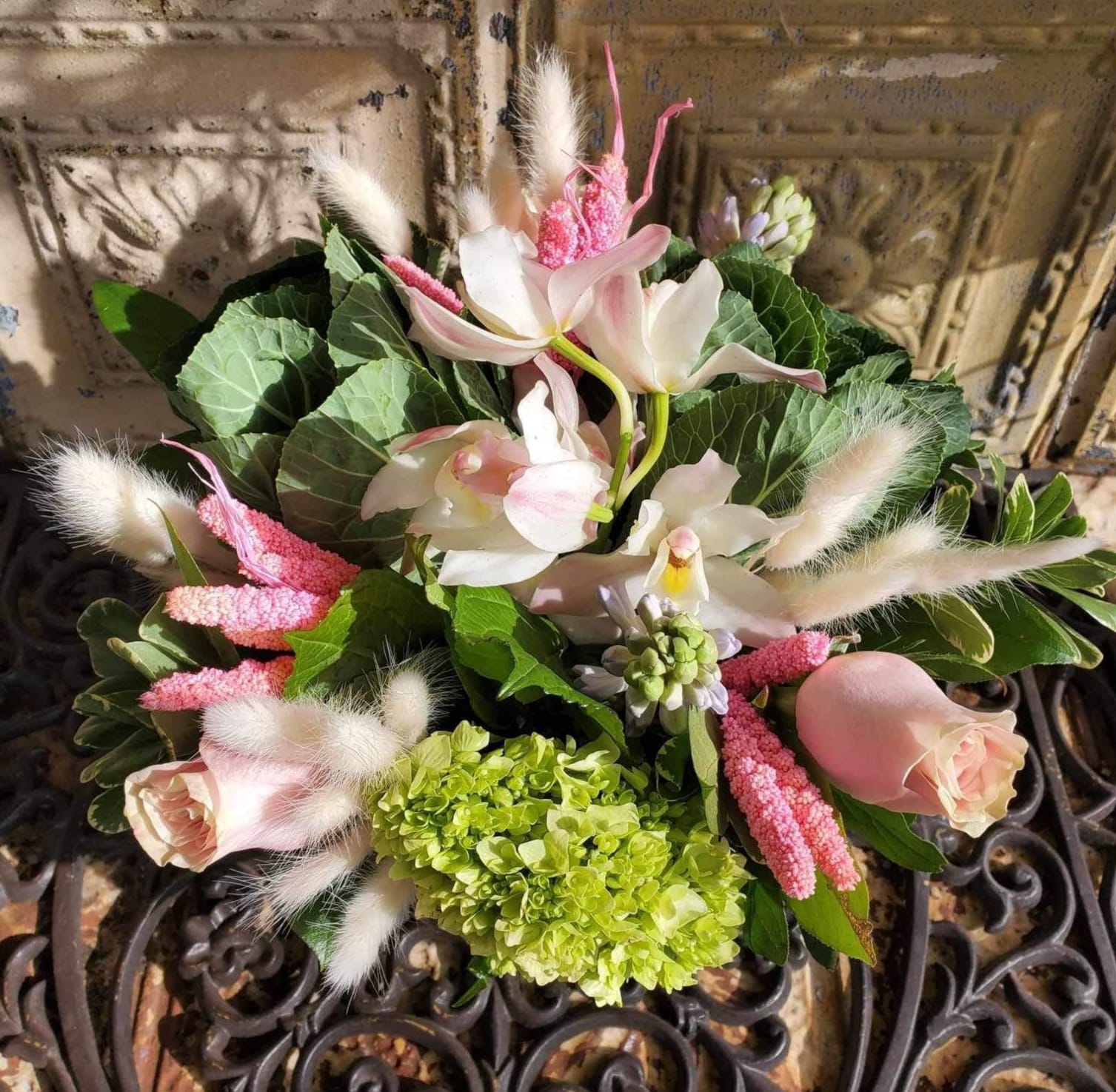 Bouquet of pale pink roses, white orchids, and green hydrangea