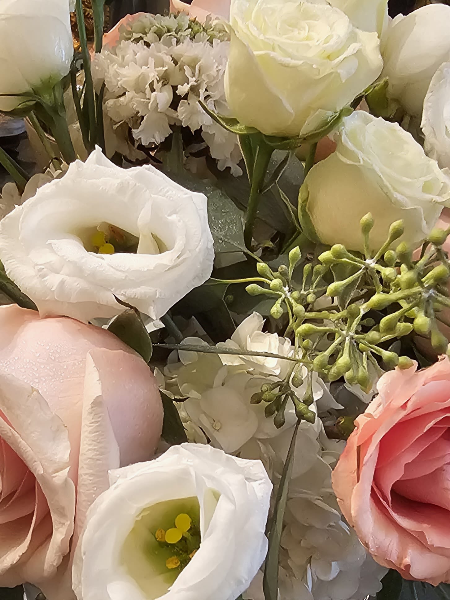 Close-up bouquet of white and pink roses with white lisianthus