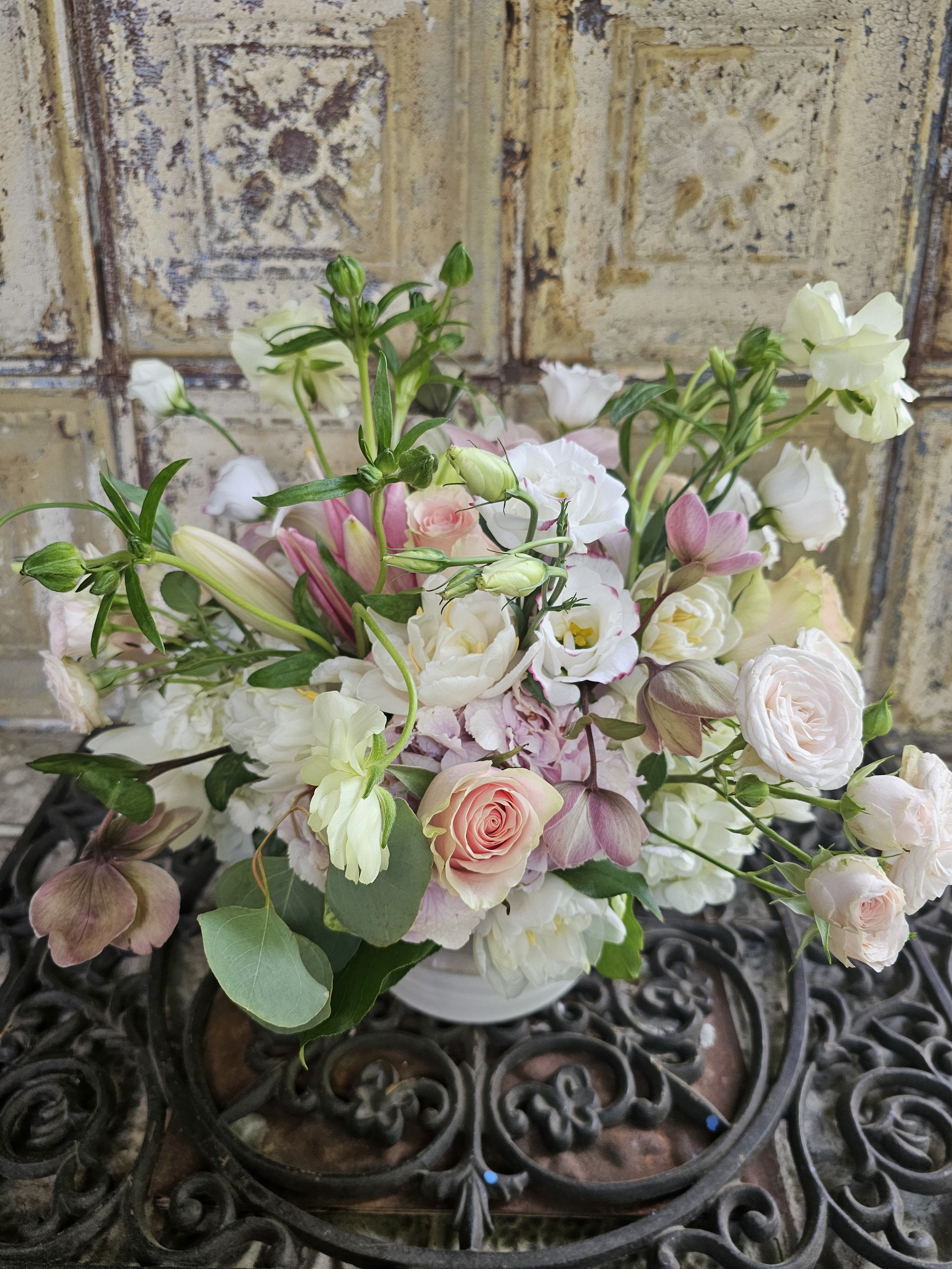 Soft pink and white mixed bouquet in a white vase