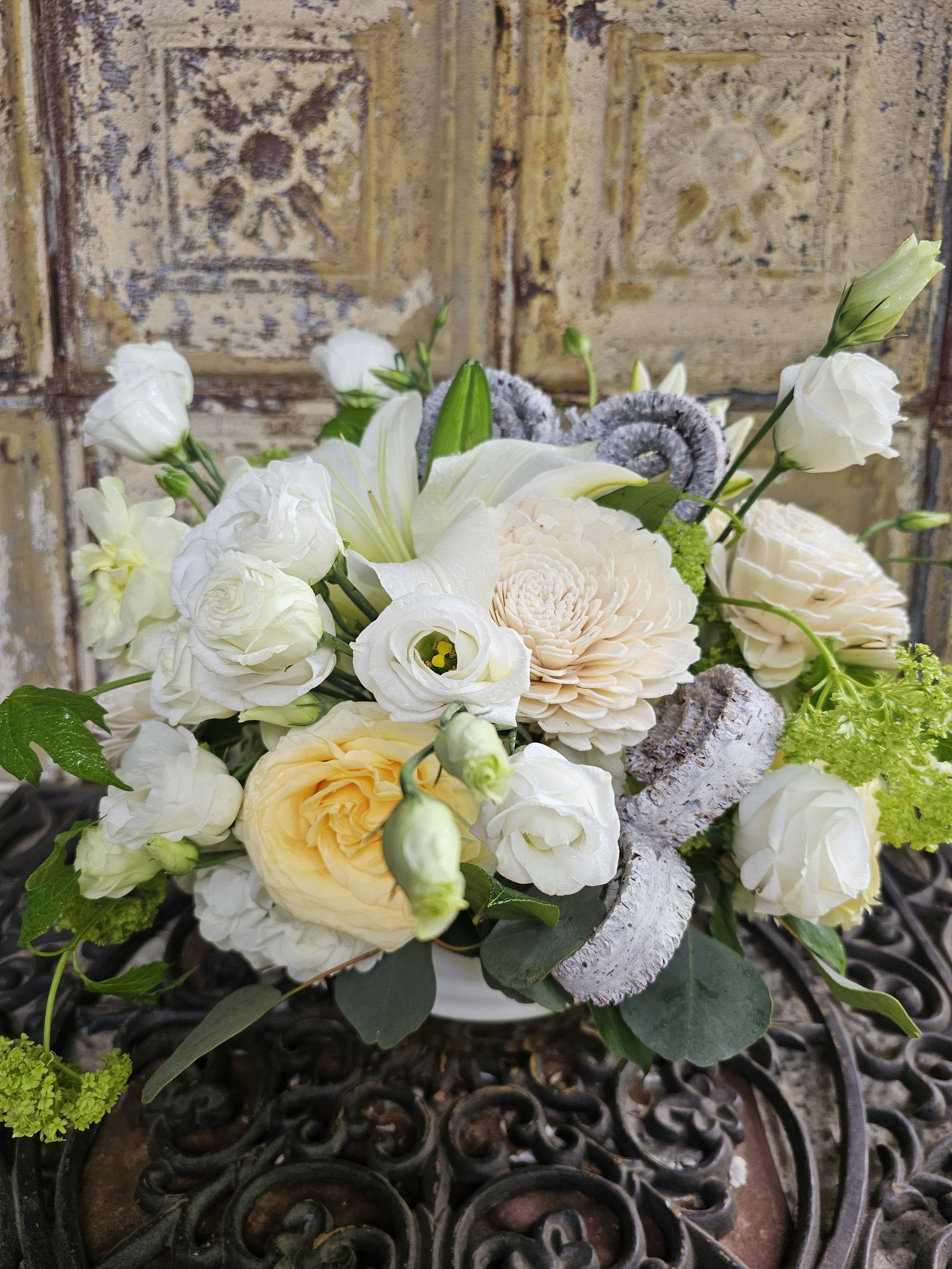White and cream bouquet with lilies and roses in a vase