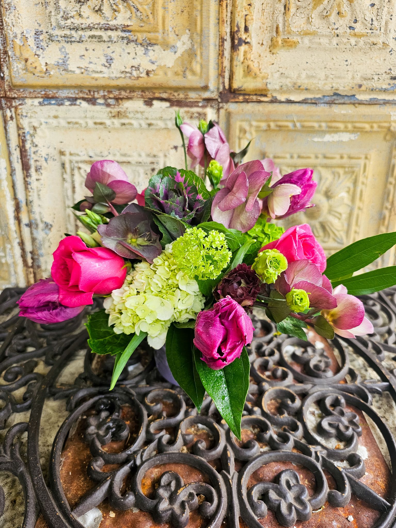 Bouquet of pink roses and purple blooms with green hydrangea