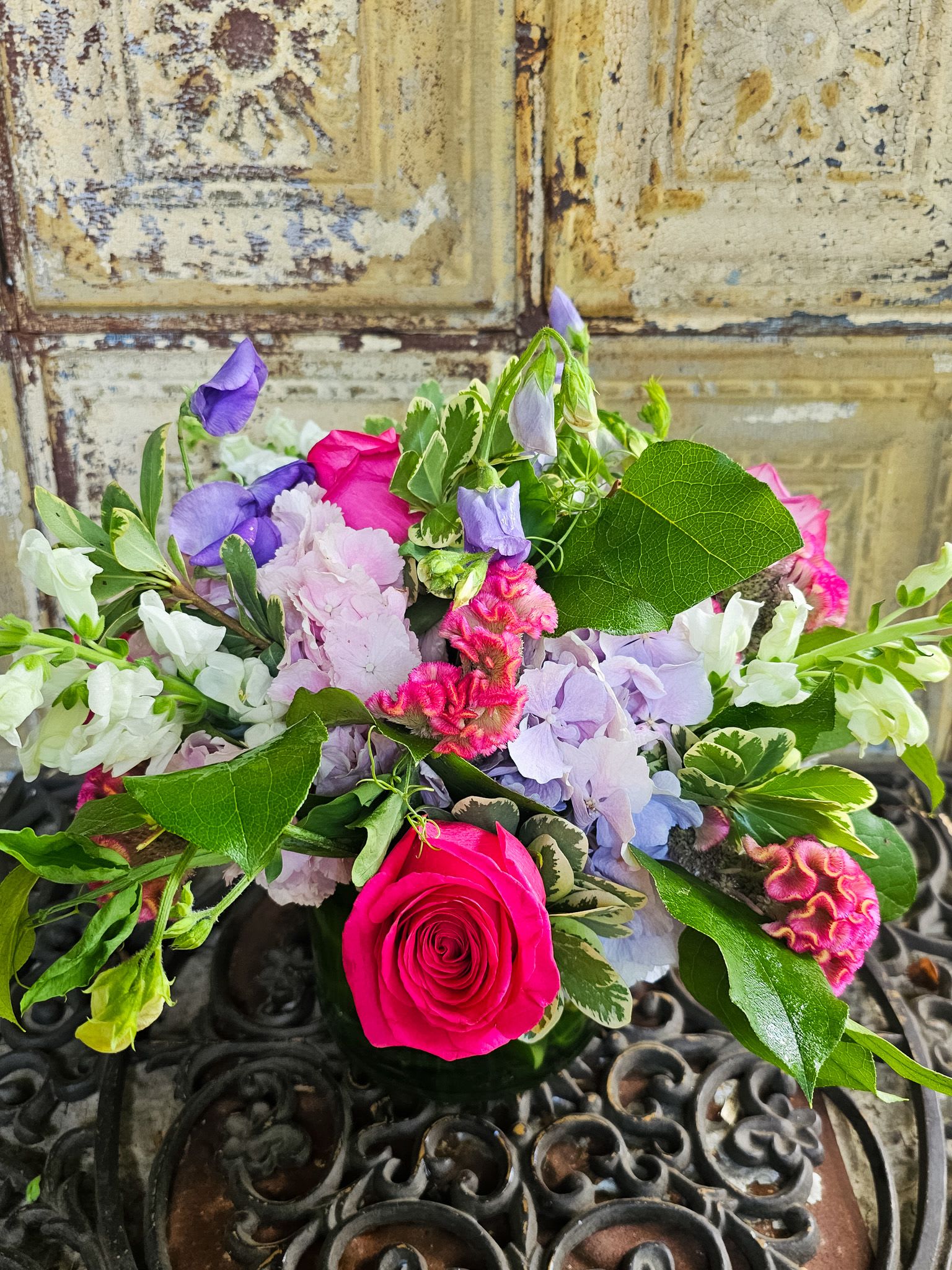Mixed bouquet with a bright pink rose and purple and white flowers