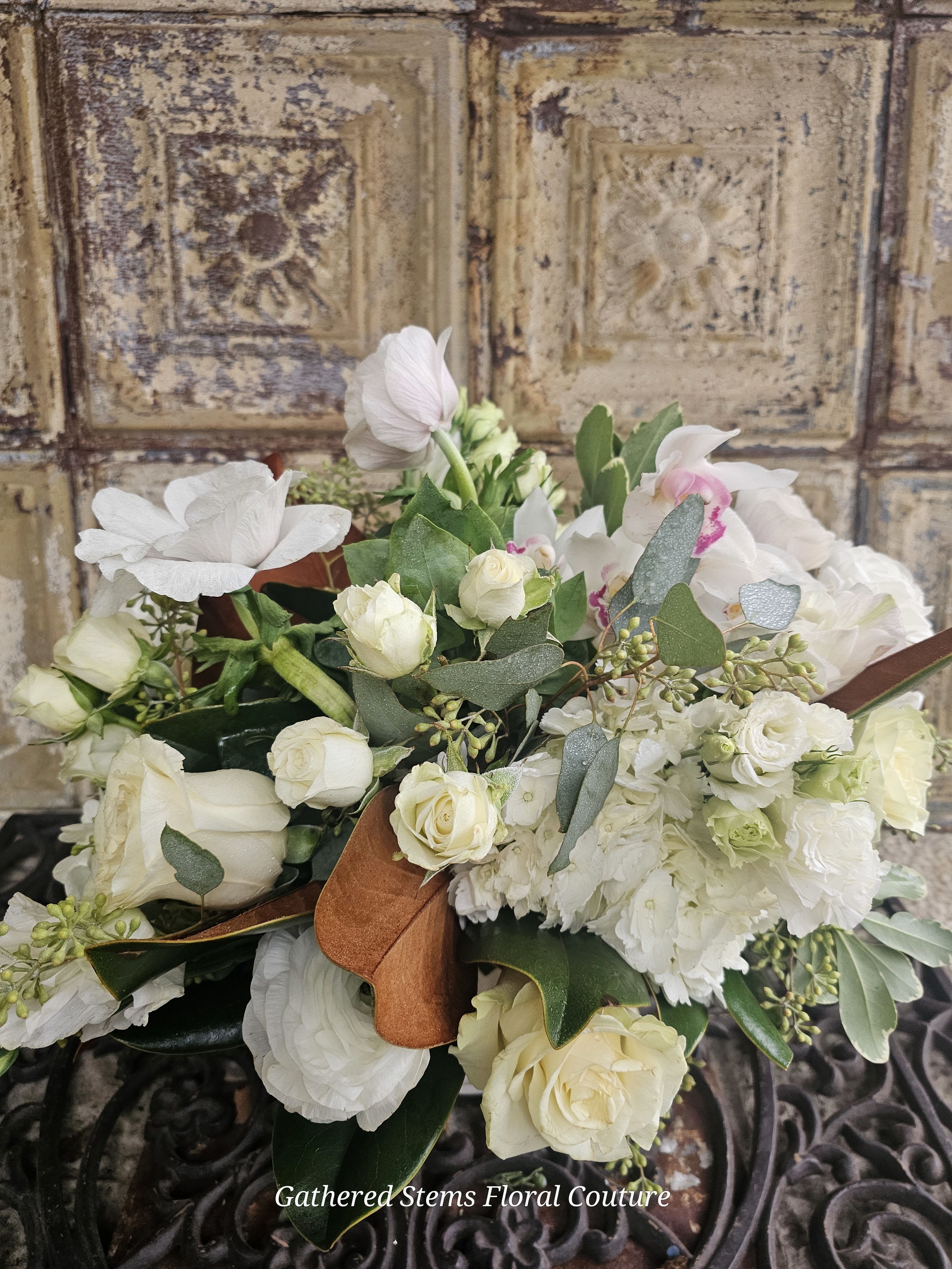 White rose and orchid bouquet with eucalyptus and ribbon