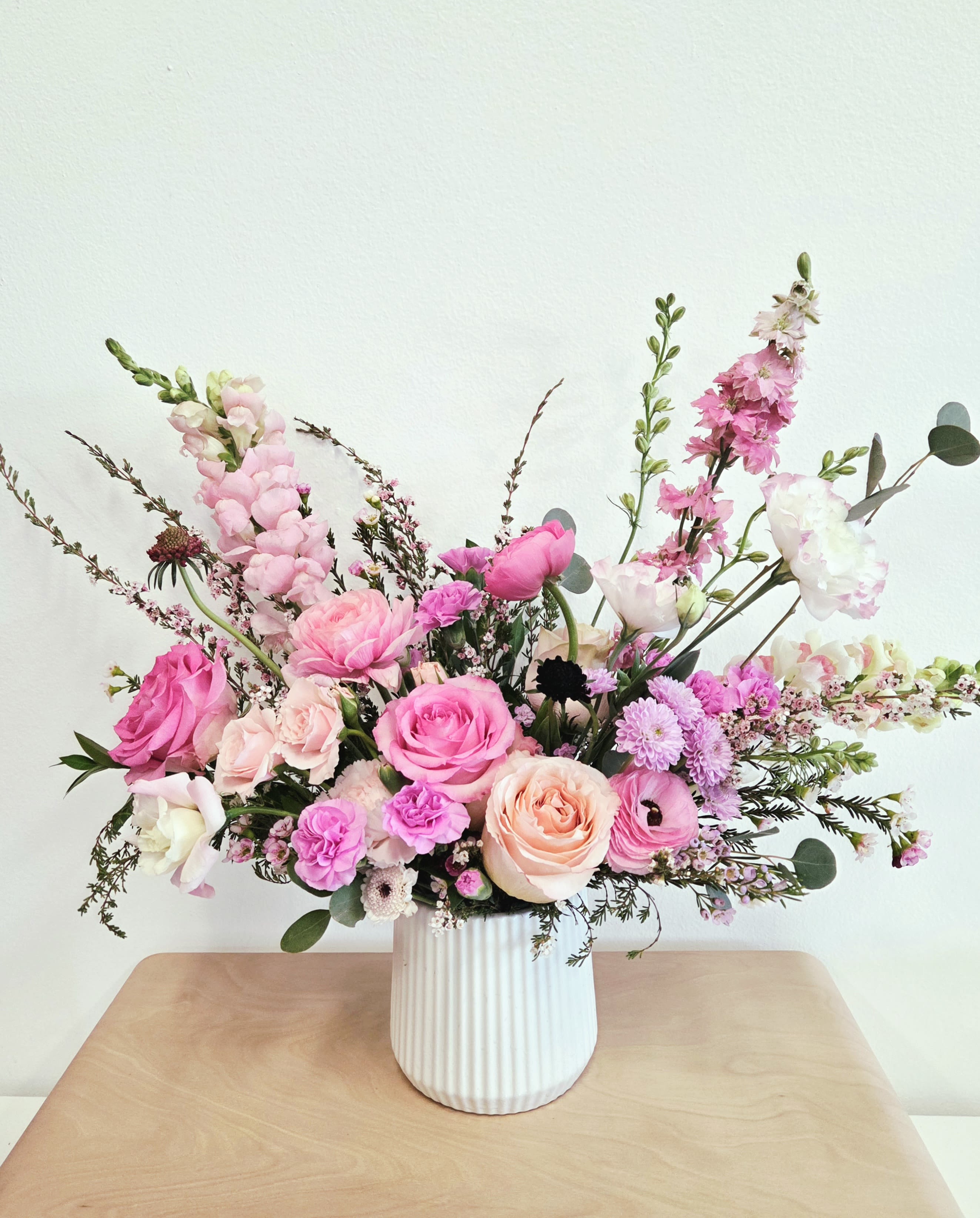 Petal Serenade (New!) - Vase Arrangement  Store Hours Mon–Fri: 9:30 a.m. – 6:00 p.m. Sat: 9:00 a.m. – 4:00 p.m. Sun: Closed  Delivery Deliveries are typically made between 9:00 a.m. and 3:00 p.m. While we are unable to guarantee specific delivery times, we will always do our best to accommodate your requests. If you prefer a later afternoon delivery, please let us know in advance and we will try to accommodate. If your delivery address requires a gate code, please provide it to ensure smooth delivery.  Pick-Up If you need to pick up before 9:30 a.m., please text us directly to place your order. (Text: 714-715-1482) Please also try to pick up your order at the scheduled time. When pick-ups are delayed during busy time slots, it may affect other customers placing orders for the same time. We appreciate your understanding!  Please Note Your arrangement may vary slightly from the photos depending on seasonal availability and store stock. However, we will match the overall color palette and ensure your flowers are fresh and beautifully designed.  Thank you!!