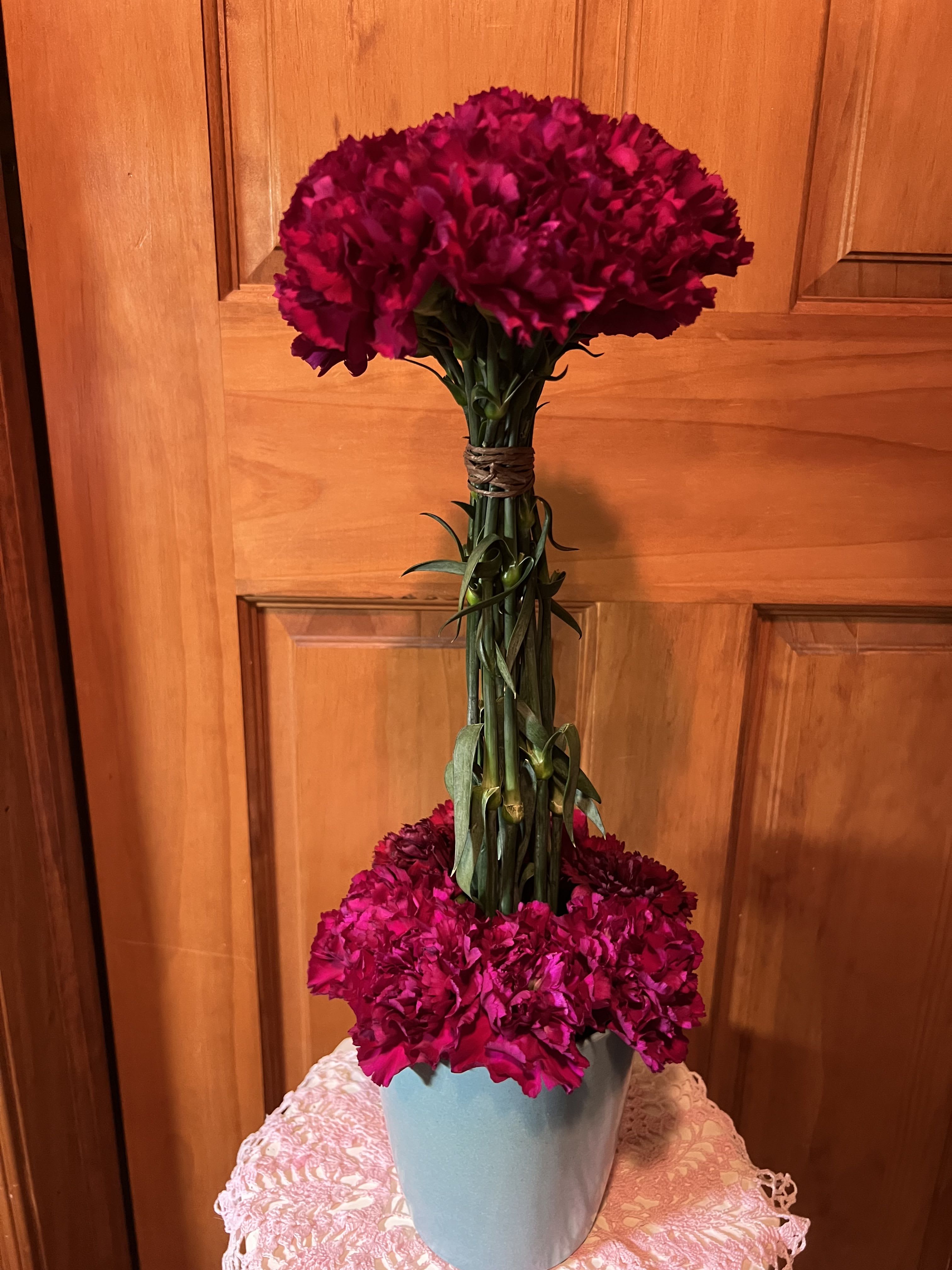 Carnation Topiary - Our deluxe choice will add additional flowers to the bouquet. Inter-dispersed between the lower carnations.