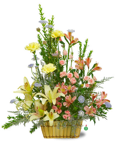 Mixed bouquet in a yellow basket with lilies, carnations, and small pink blooms