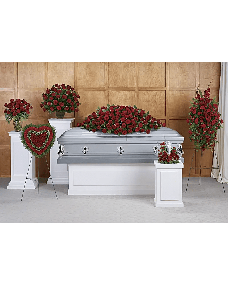 Red rose funeral casket spray with matching standing arrangements