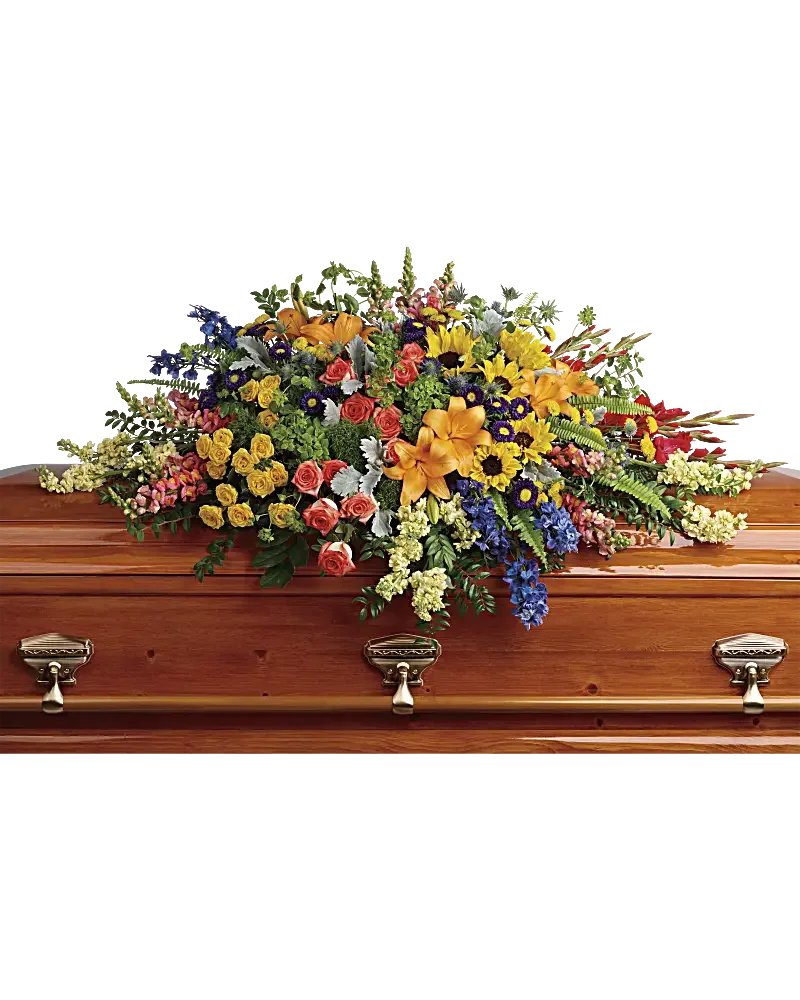 Colorful floral casket spray on a wooden coffin