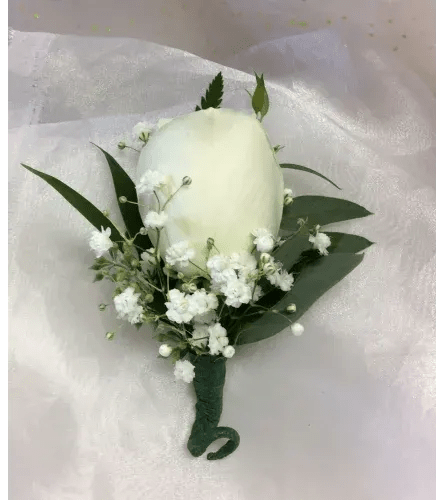 White rose boutonniere with baby's breath and dark green leaves