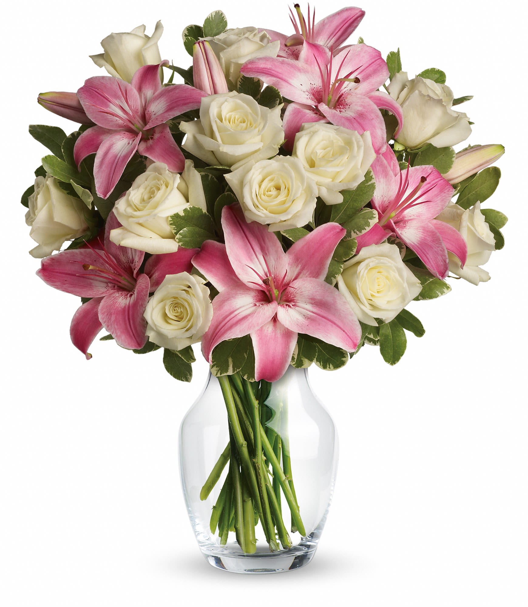 Pink lilies and white roses arranged in a clear glass vase