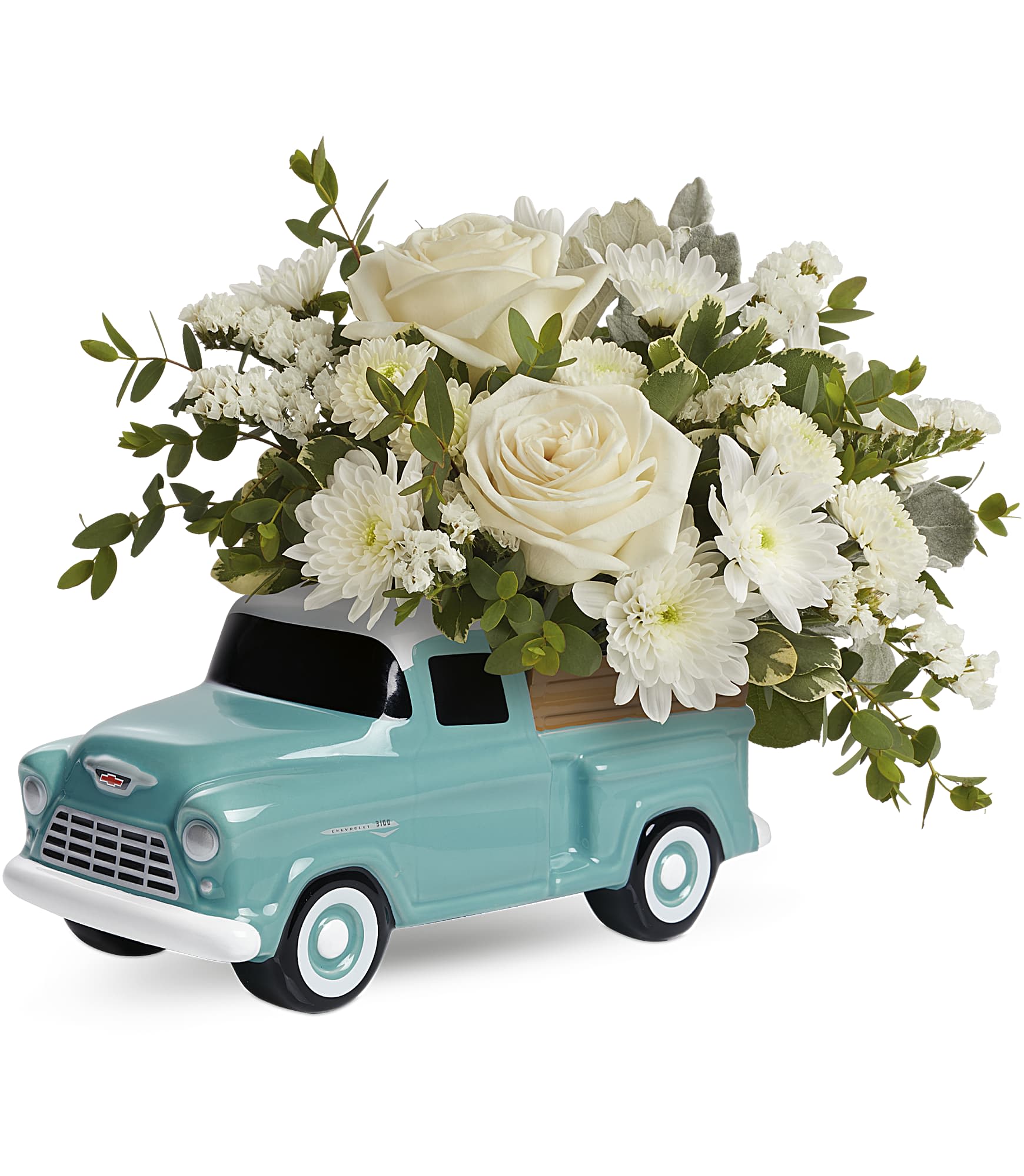 White roses and daisies arranged in a turquoise truck planter
