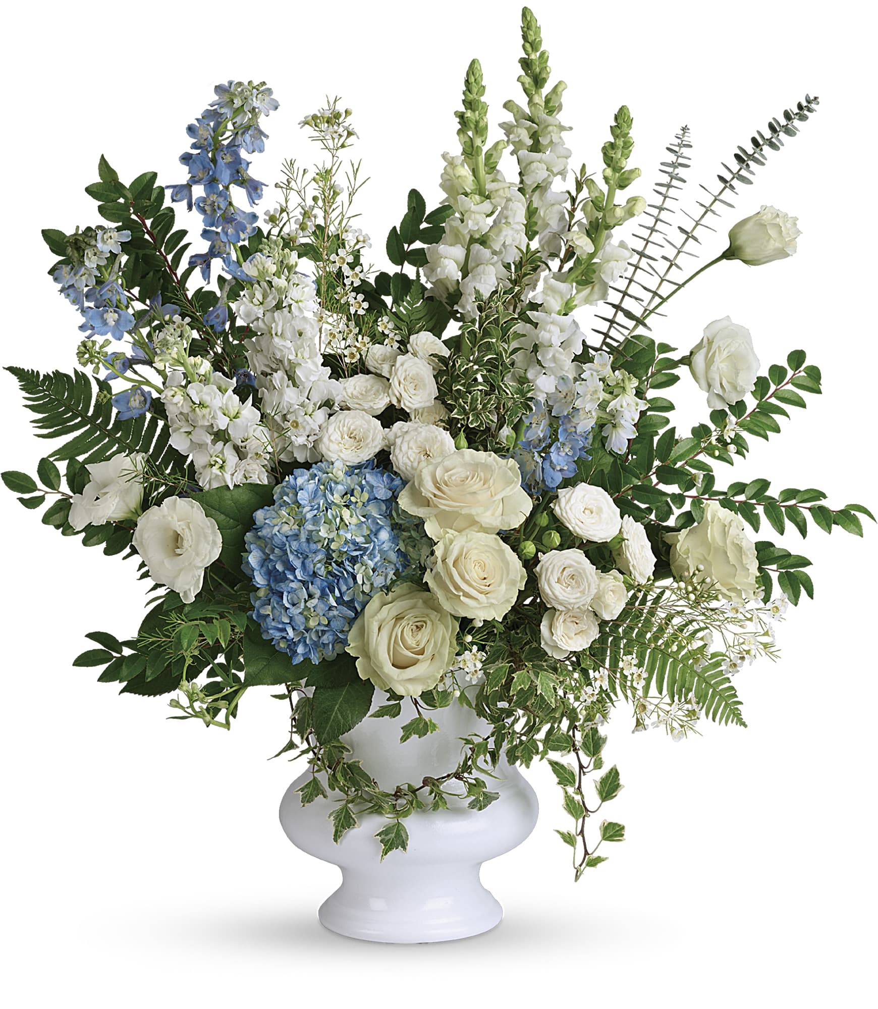 White and blue floral arrangement in a white pedestal vase