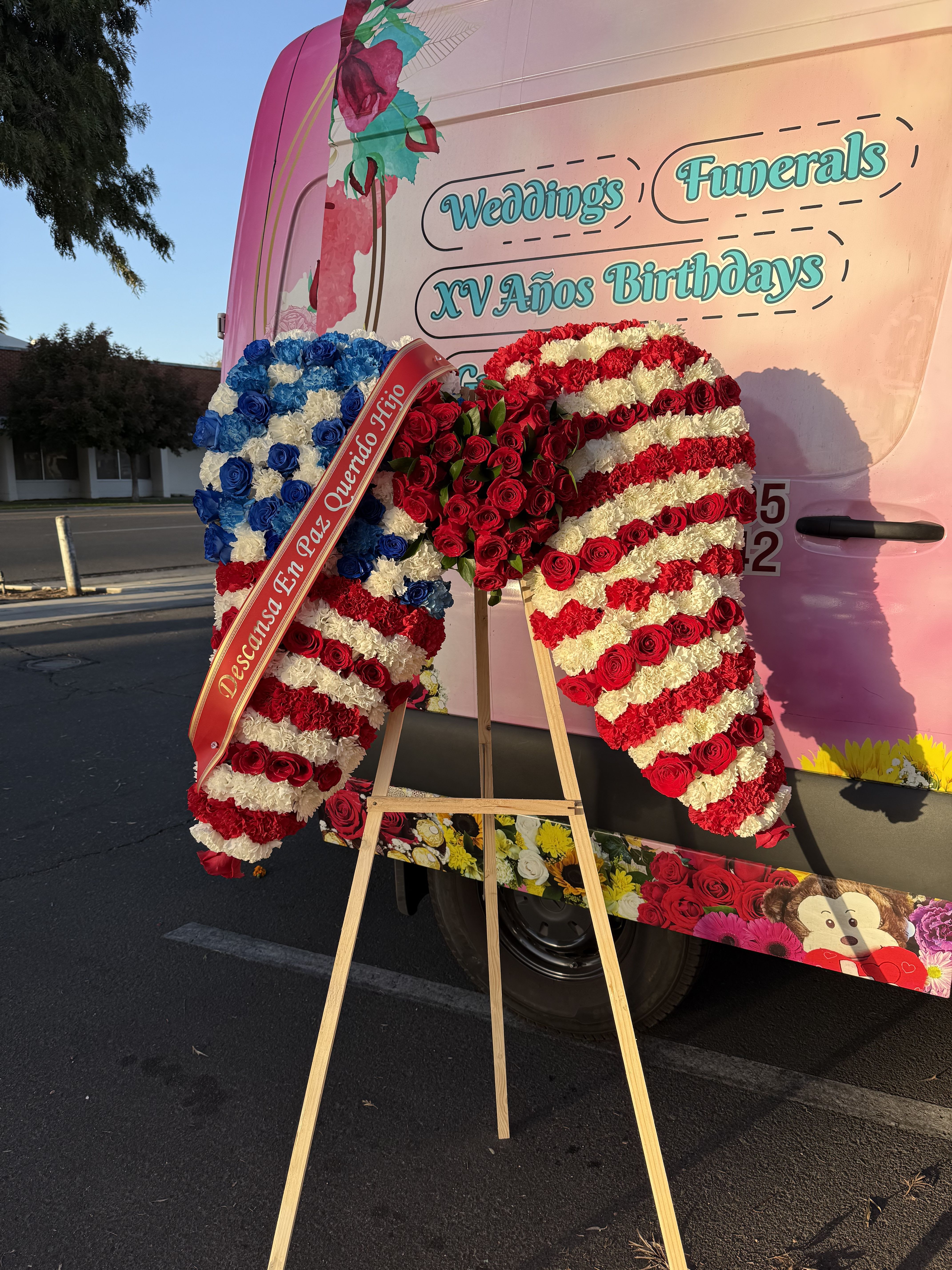 Large floral standing display in red, white, and blue on an easel