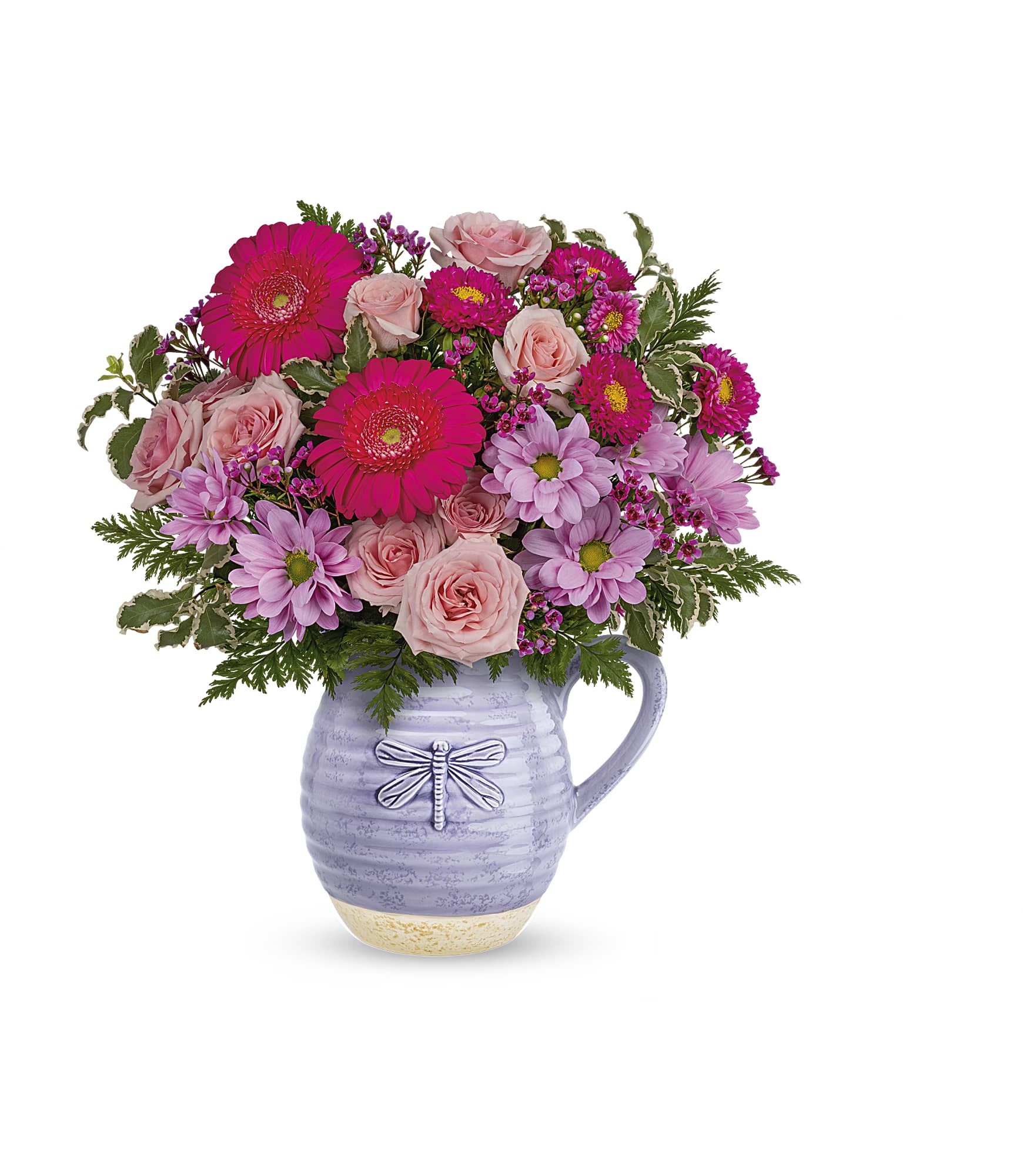 Pink and lavender flowers arranged in a lavender pitcher vase