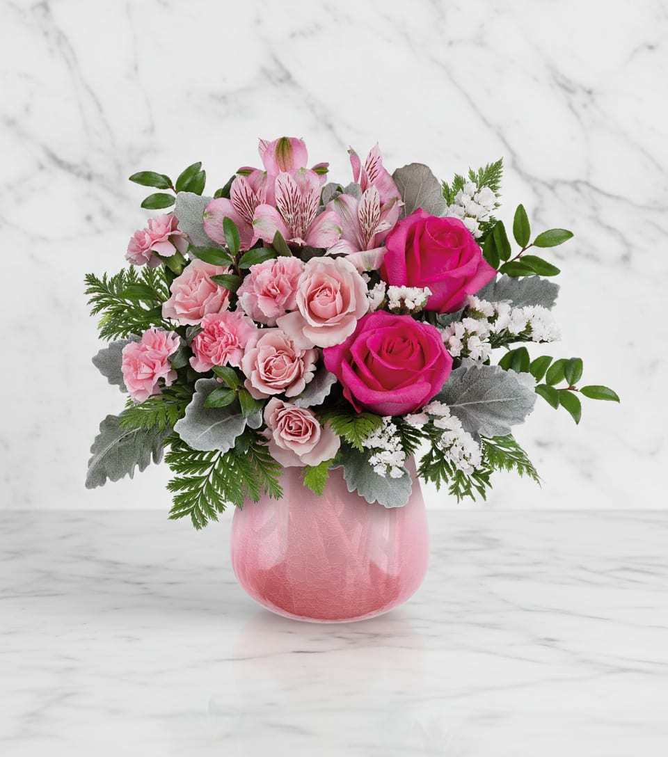 Pink roses and alstroemeria in a pink glass vase