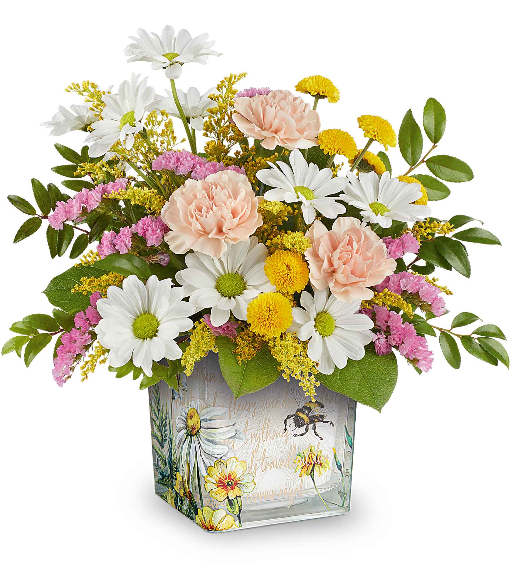 Honey Kissed Bouquet - Their heart will buzz like a busy bee when this enchanting floral gift arrives, featuring serene blooms in a keepsake glass cube adorned with delightful vintage garden imagery.  This bouquet showcases a delightful mix of peach carnations, yellow button spray chrysanthemums, white daisy spray chrysanthemums, pink sinuata statice, all beautifully arranged with solidago, huckleberry, lemon leaf for added texture. Teleflora's Honey Kissed Bouquet is presented in the charming Teleflora's Floral Buzz Cube. Approximately 13 1/2" W x 12 1/2" H