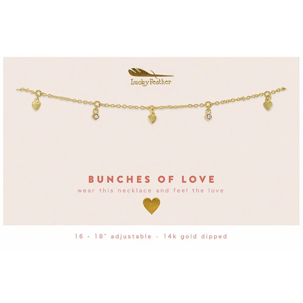Gold charm necklace with small heart and crystal pendants on a cream card reading 'Bunches of Love'.