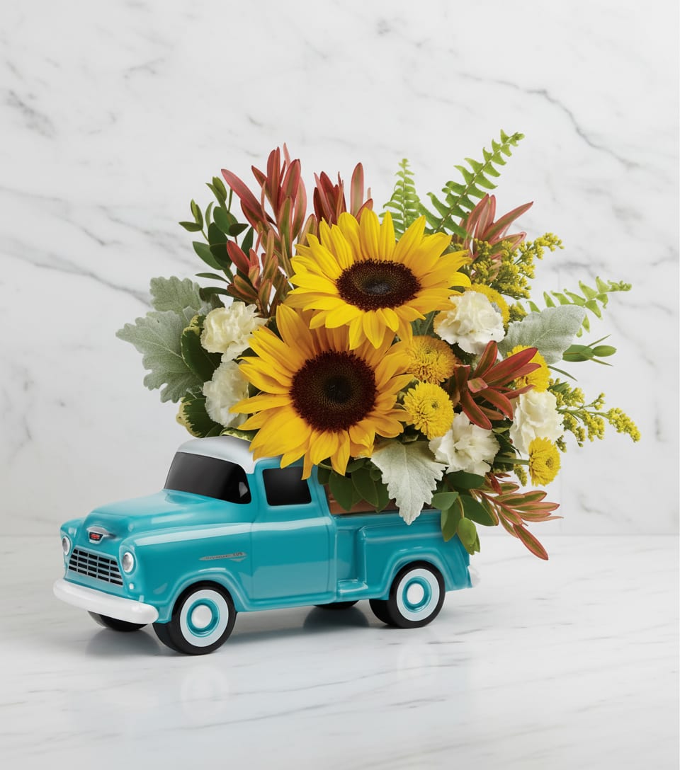 Sunflowers arranged in a turquoise toy truck