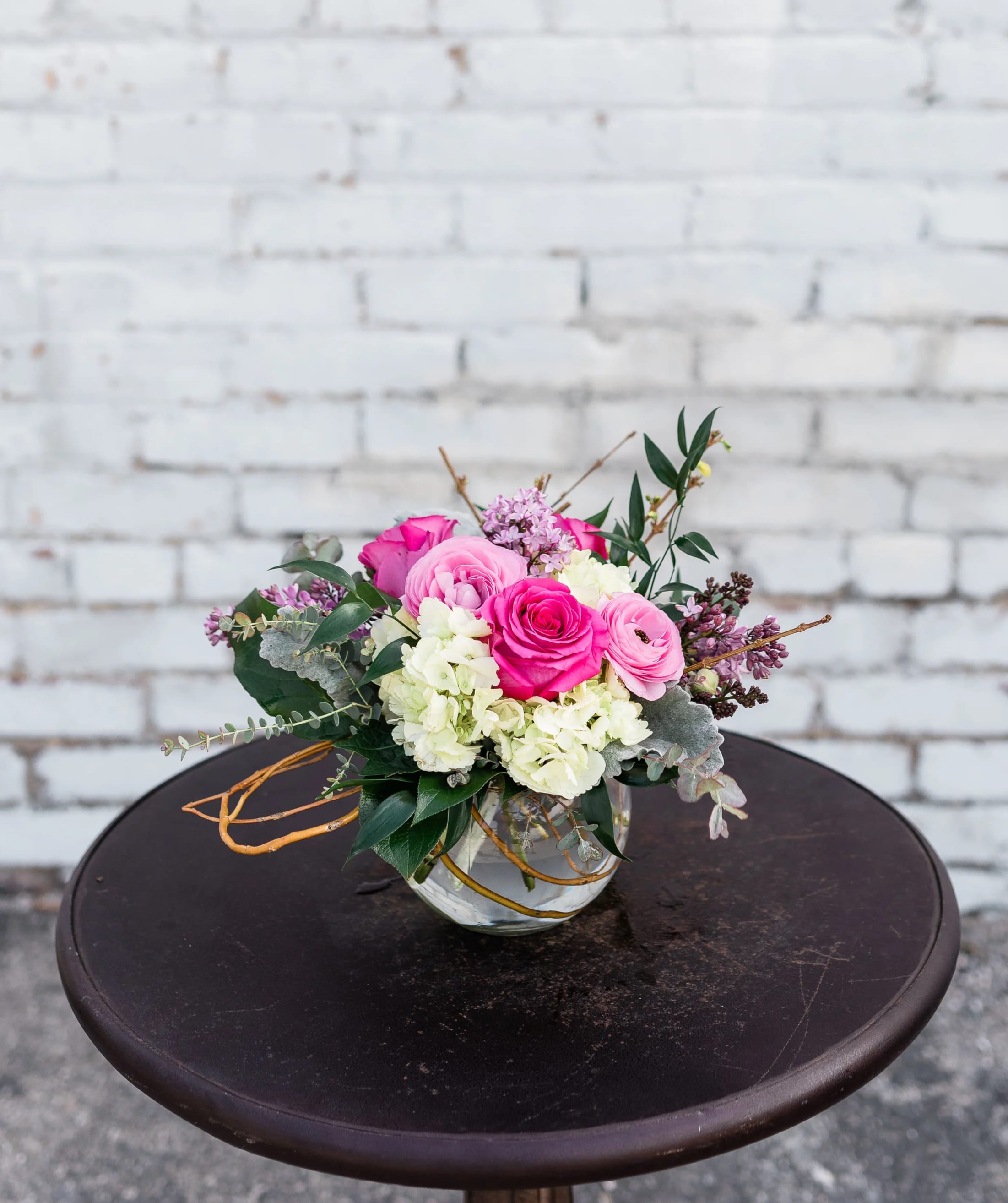 Pink and white rose bouquet in a clear glass vase