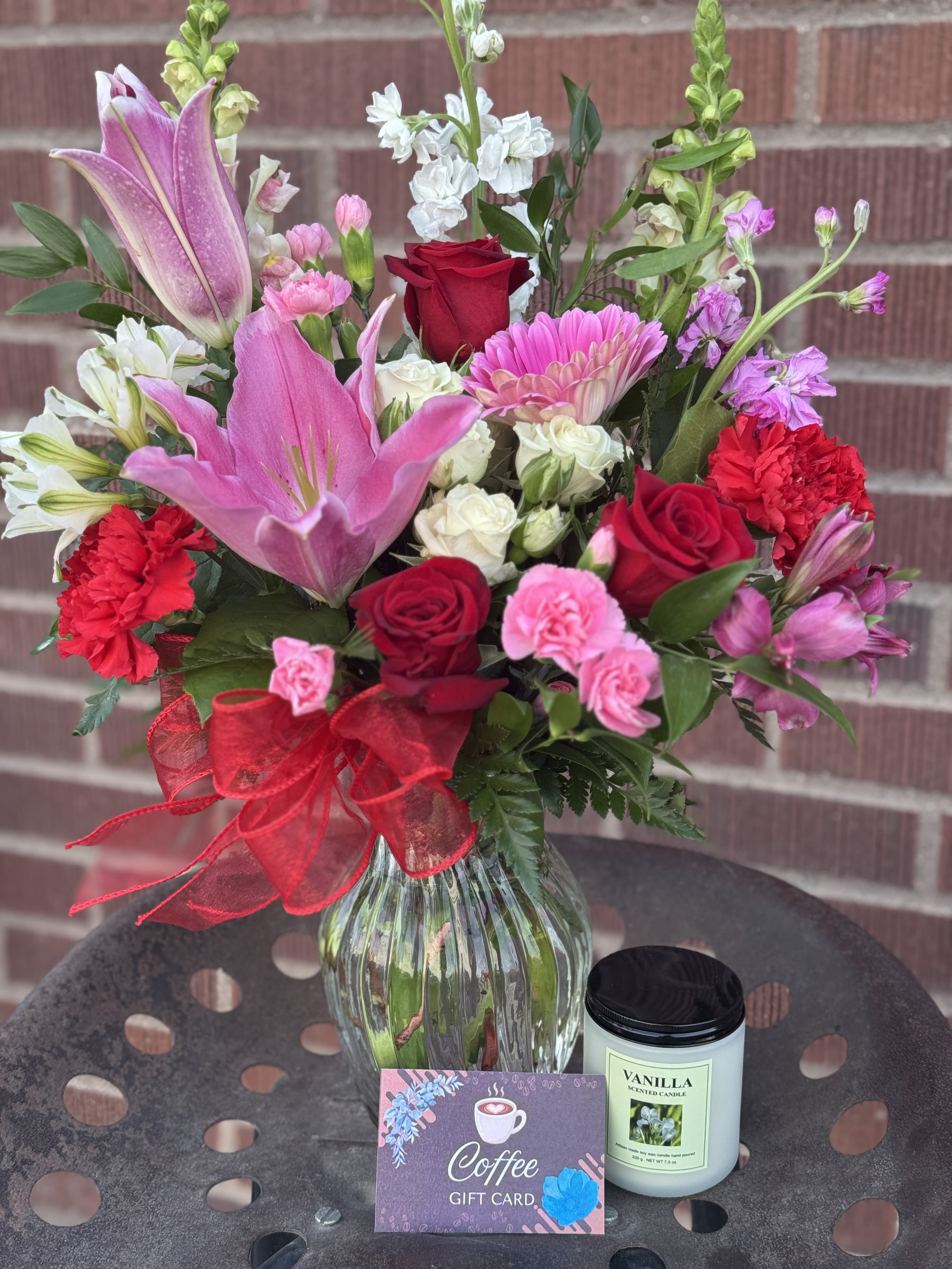 Mixed bouquet in a glass vase with a coffee gift card and vanilla candle