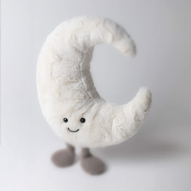 Plush crescent moon with a smiling face and small feet