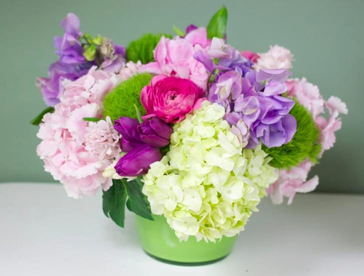 Designers Choice Glass Vase - Designers Choice with Green, Pink Hydrangeas, Lavender Sweet Peas, Purple Tulips and peonies Approx. 12"Wide X 10" High