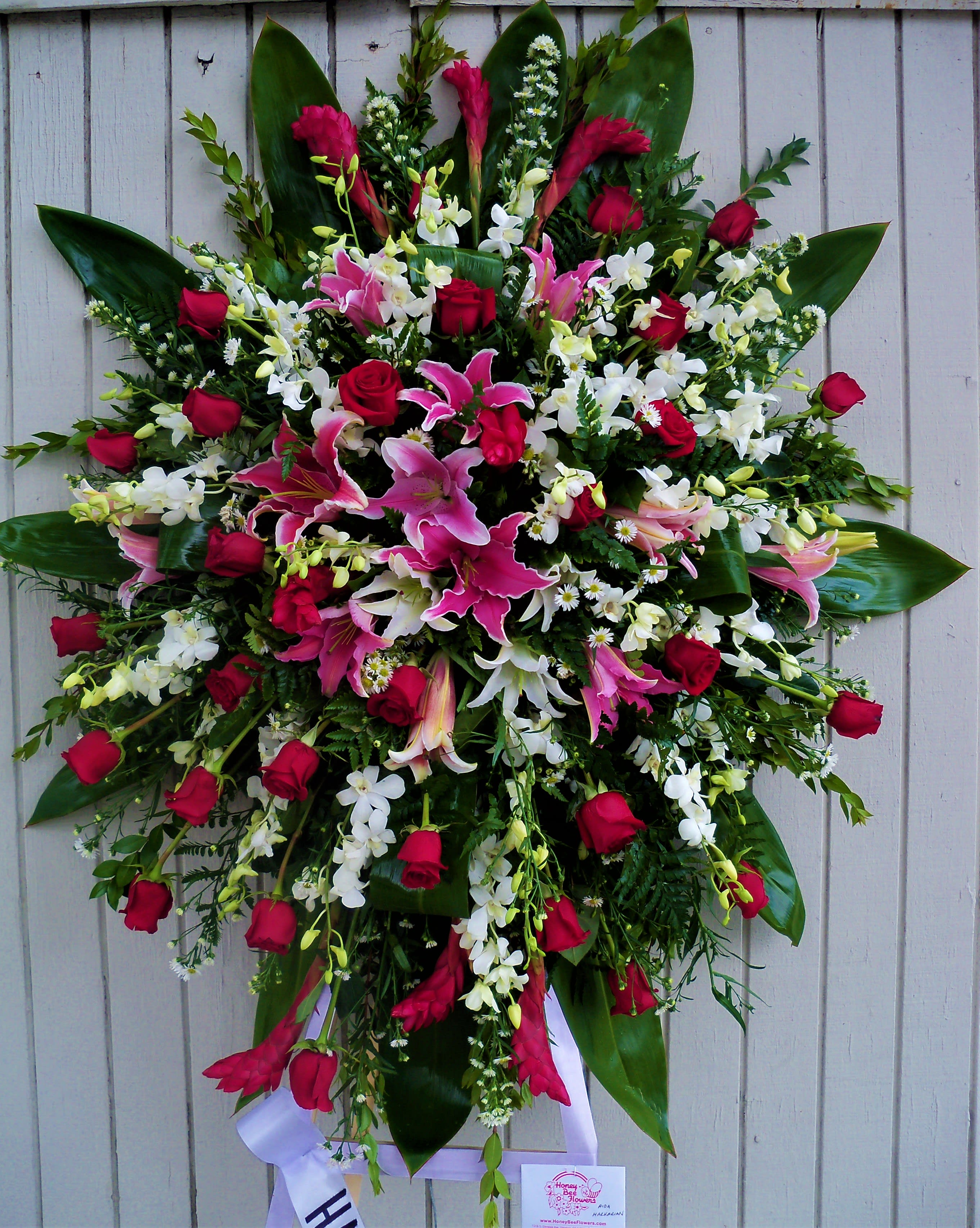 Tropical Spray - An assortment of premium flowers which include orchids, ginger, stargazer lilies, casablanca lilies, roses and other mixed greenery. This standing spray comes on a 6ft easel. Colors may be customized, please let us know in the section for special instructions