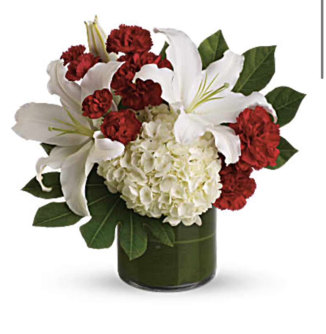 White lilies and red carnations in a dark glass vase