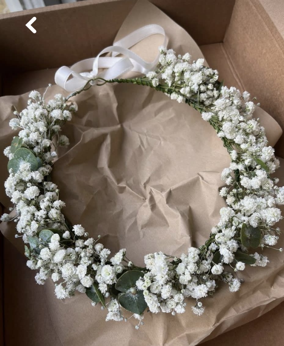 White baby's breath floral crown with ribbon ties in a box