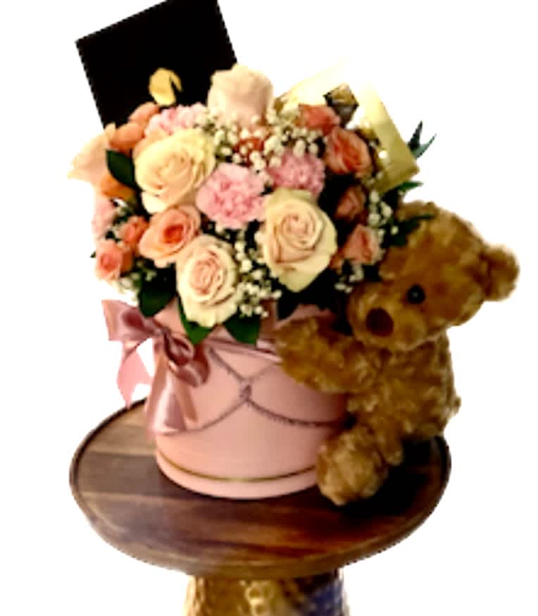 Pink and peach rose bouquet in a pink hatbox with a teddy bear