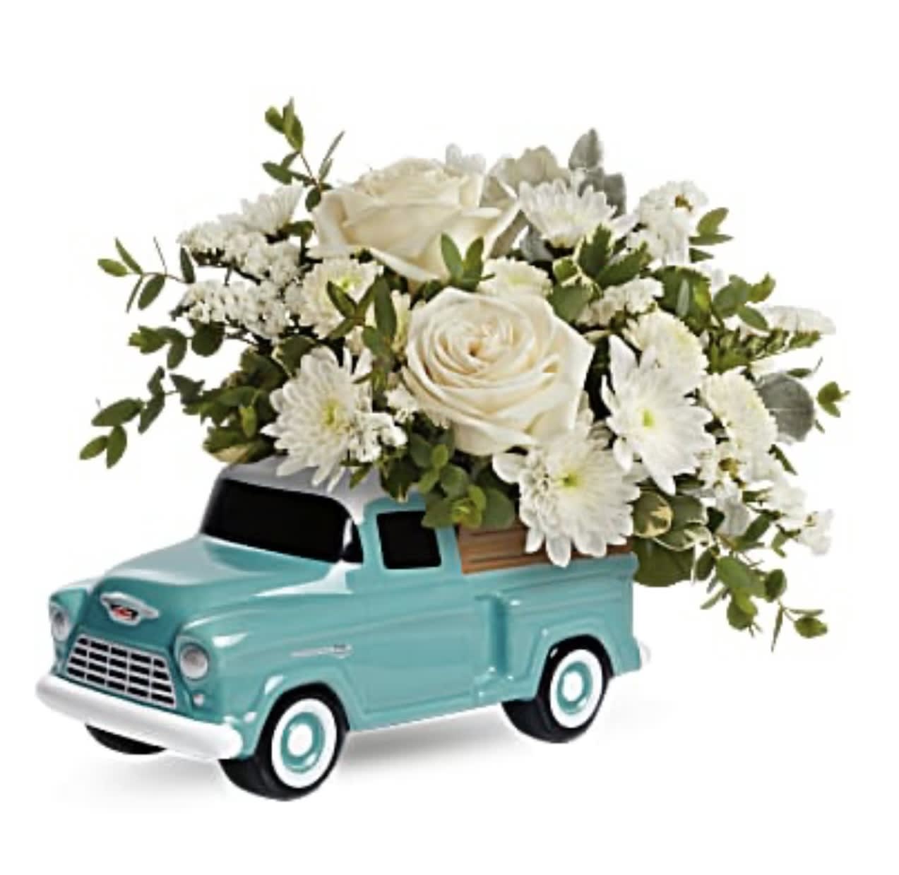 White roses and daisies arranged in a turquoise toy truck