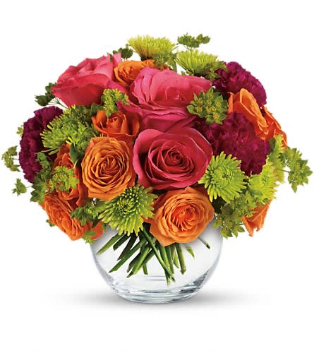 Bouquet of pink and orange roses with green mums in a clear glass vase