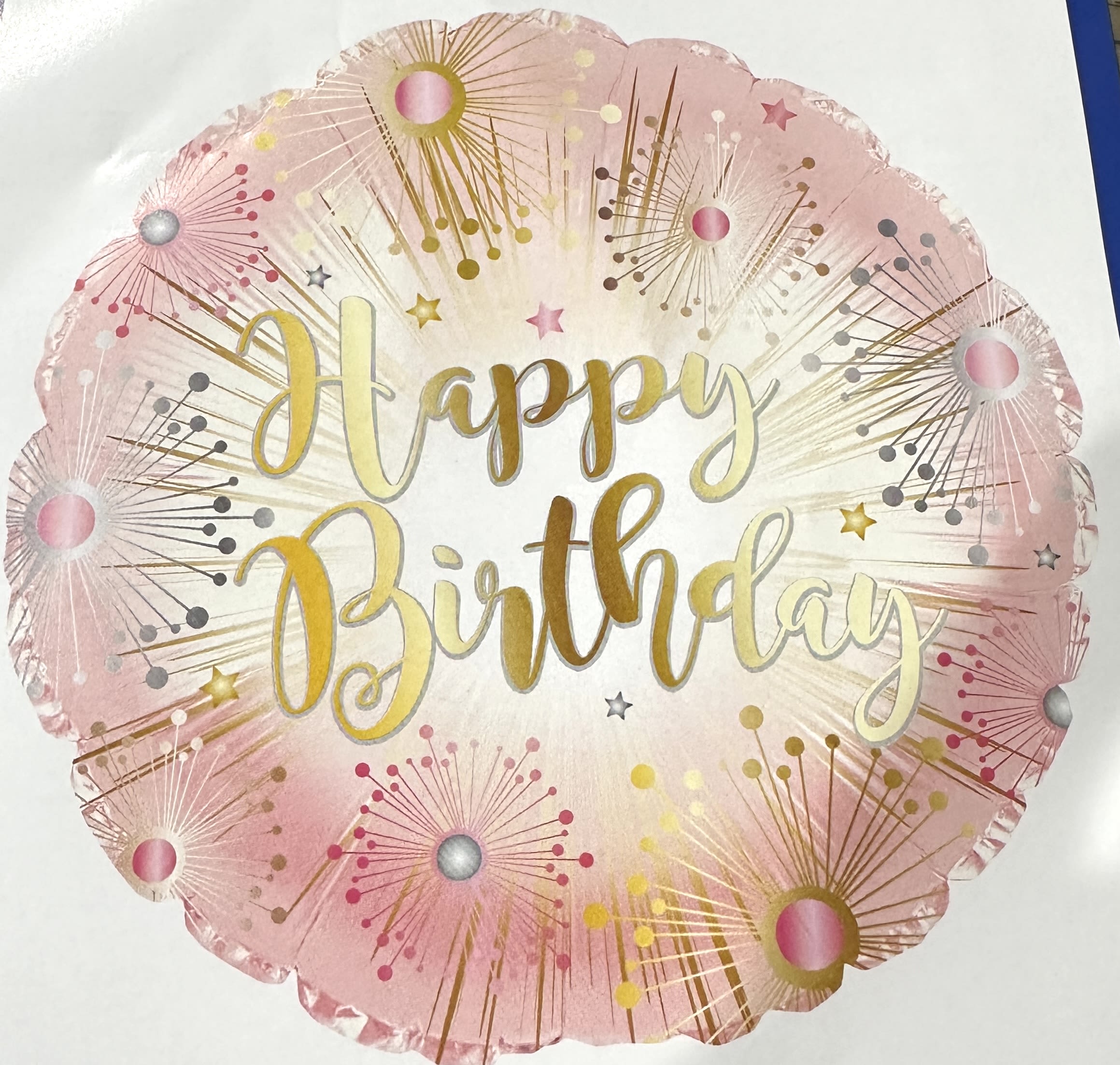 Round pink and gold Happy Birthday balloon with sparkler-style bursts around the edge