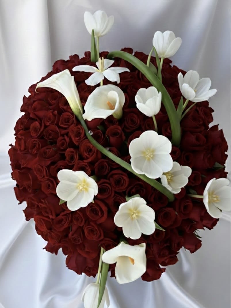 Heart-shaped bouquet of red roses with white calla lilies and tulips