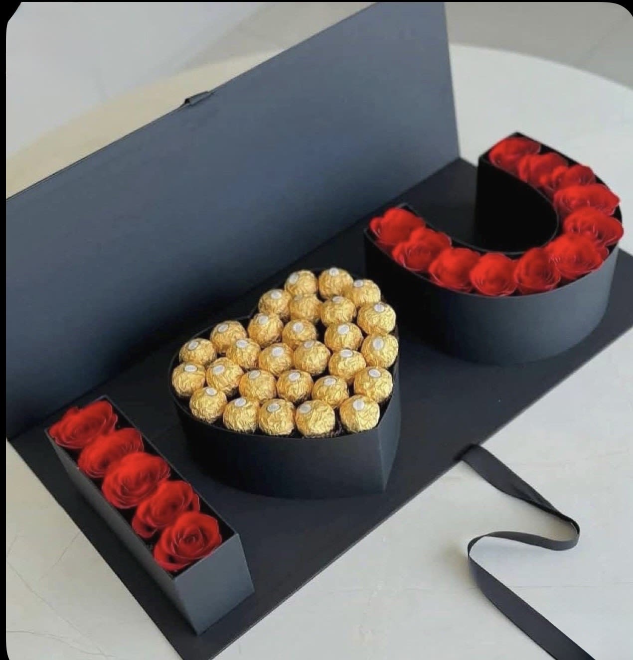 Heart-shaped gift box with red roses and gold-wrapped chocolates