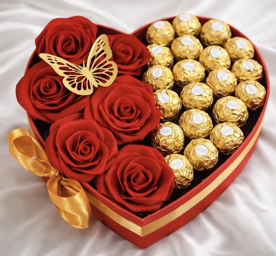 Heart-shaped box with red roses and gold-wrapped chocolates